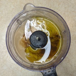 Pureeing tahini, and garlic/lemon juice