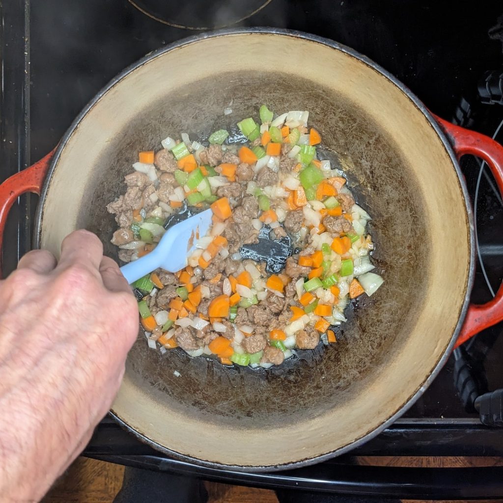 Frying vegetables and sausage