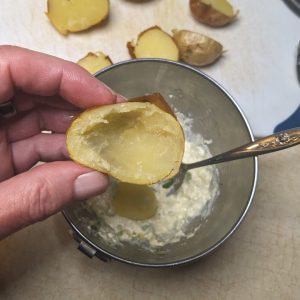 Scooping flesh from potato