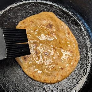 Cooking second side of vegan naan